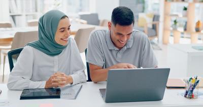 Stock image people sitting in front of laptop